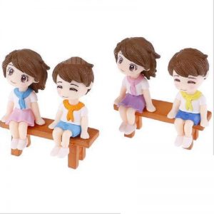 Miniature Cute Boy And Girl Sitting On A Bench