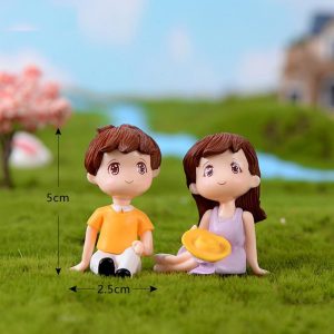 Miniature Boy And Girl Sitting With Cap