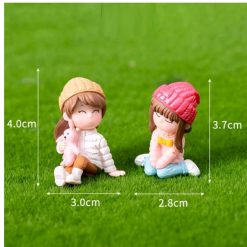 Miniature Cute Girls Sitting In Garden